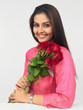 a happy woman with a bouquet of red roses