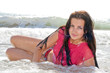 The beautiful young woman lies on sea coast