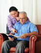 portrait of mature man and his wife holding book and reading
