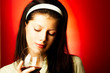 young pretty caucasian woman with wine over red