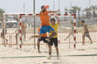 Handball player jumping with the ball on a handball beach matc