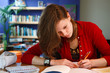 Photo: young female student doing her homework young female student doing her homework