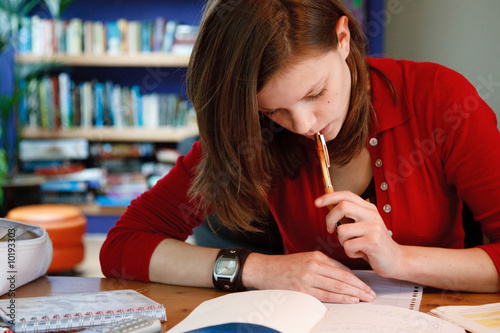 Photo: young female student doing her homework young female student doing her homework