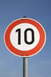 a german speed limit sign outdoors