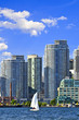Sailboat sailing in Toronto harbour with scenic waterfront view