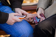 Youngs man and woman hands hold mobile phones