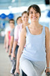 beautiful woman at the gym doing free weight smiling