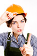 Pretty businesswoman with  helmet pointing. Hi key