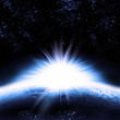 Illustration: The sun rising above the earths surface. The sun rising above the earths surface.