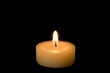 Little candle isolated on black background