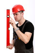 Construction worker checking the level with spirit level