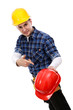 Construction worker offering red hardhat