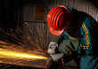 heavy industry manual worker with grinder