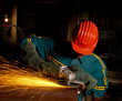 heavy industry manual worker with grinder