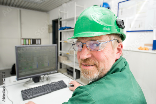 Industrial worker in his office in front of a pc