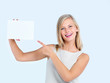 Young woman pointing towards copyspace
