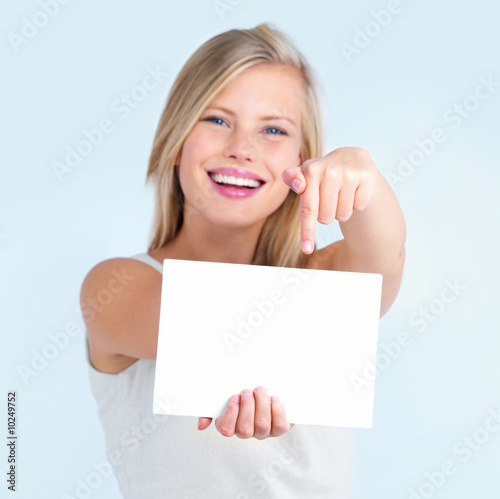 Photo: Cut out of girl pointing down at billboard Cut out of girl pointing down at billboard