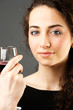 young pretty caucasian woman with wine over grey