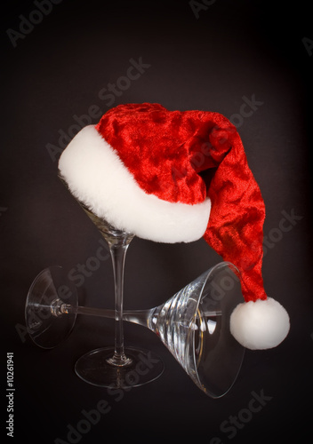 Photo: Santa hat and martini glasses on black background Santa hat and martini glasses on black background