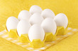 a group of eggs on a yellow tray