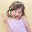 The small girl wearing a head to headset.