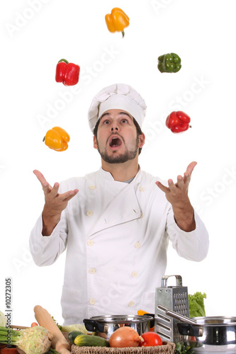 Photo: funny chef juggling with peppers in colors funny chef juggling with peppers in colors