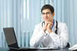 Portrait of happy successful doctor at office
