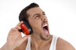 young guy enjoying rock music with full volume on background