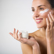 Woman applying lotion.
