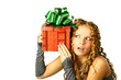 Foto: The girl with a gift in cheerfully box smiles new year The girl with a gift in cheerfully box smiles new year