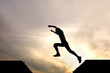 silhouette of jumping boy against sunset