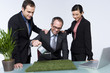 Business people watering grass