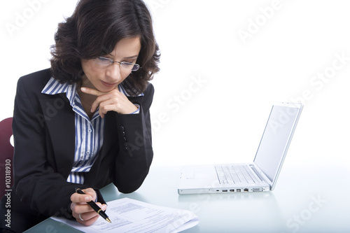 Photo: Young business woman at her workplace Young business woman at her workplace