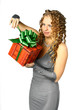 Foto: The girl with a gift in cheerfully box smiles new year The girl with a gift in cheerfully box smiles new year