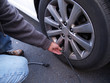 man checking air pressure in car tire man checking air pressure in car tire