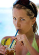 Beautiful young woman drinks on the beach drink Beautiful young woman drinks on the beach drink