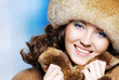 CLose-up beautiful face of young woman in fur hat