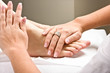 Woman's hands giving a healthy foot massage