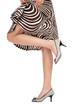Slim legs of woman in stylish peep-toes and striped dress