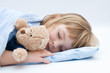 little girl sleeping and hugging her teddy bear