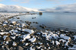 Photo: Looking across a lake with freshly fallen snow on the stones Looking across a lake with freshly fallen snow on the stones