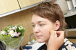 A cosmetologist applies face make-up for a woman