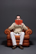 Young man reading a book, surprised expression