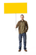 Casual young man holding a placard / sign, looking straight on
