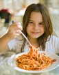 Photo: young girl eating spaghetti in restaurent young girl eating spaghetti in restaurent