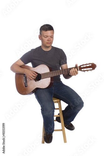Photo: Guitarist playing isolated on a white background Guitarist playing isolated on a white background