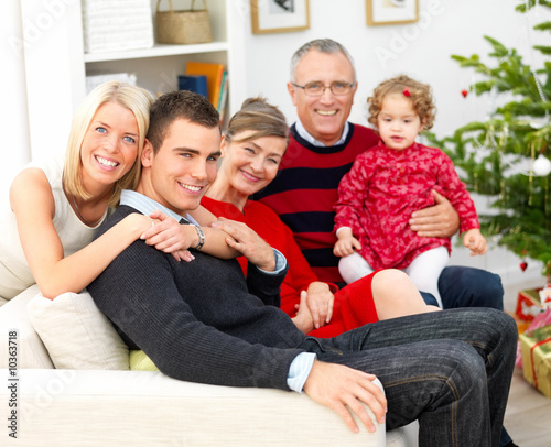 Photo: Portrait of a family sitting together at christmas Portrait of a family sitting together at christmas
