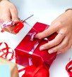 Womans hands wrapping a christmas present