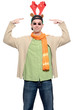 Casual young man pointing at fake reindeer horns