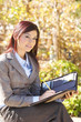 Business woman taking notes outside Business woman taking notes outside